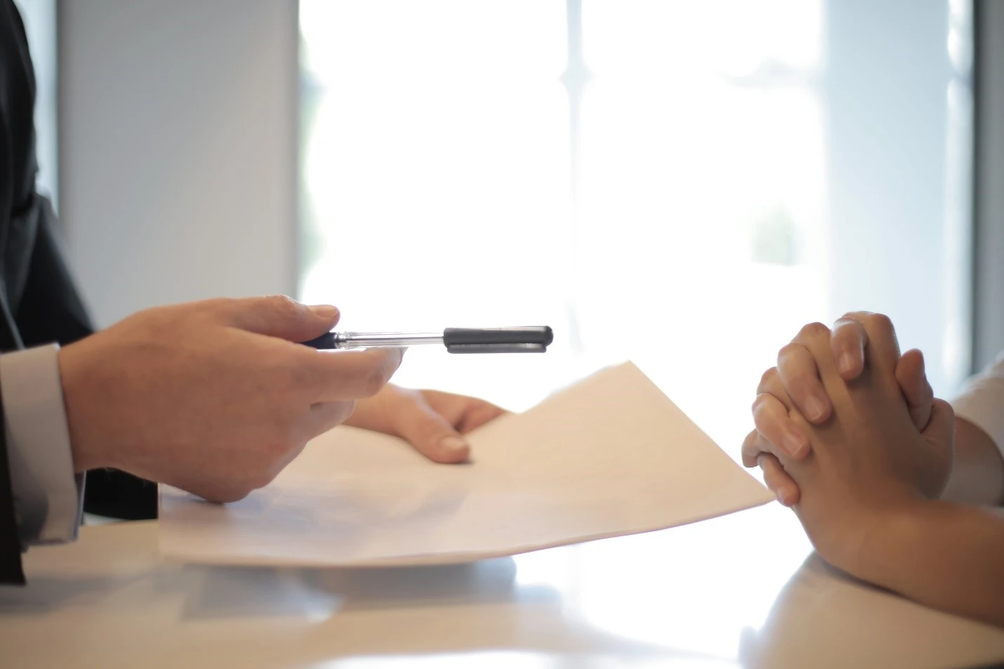 Person handing over line of credit contract to someone else.