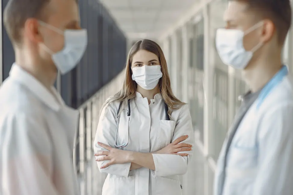 Three doctors standing in a hallway