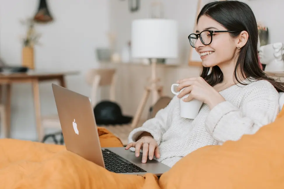 Person looking up how to apply for a loan in Canada on their computer. 