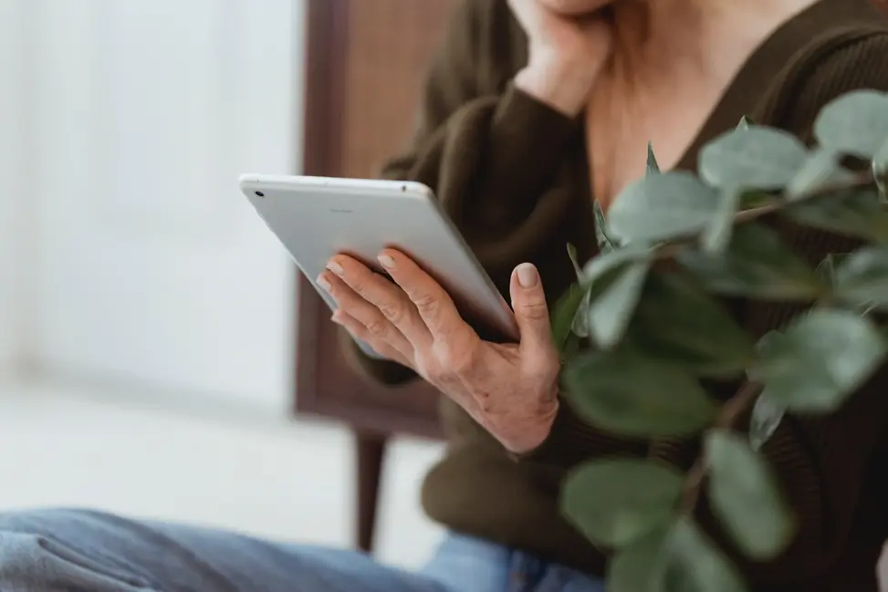 Person researching emergency loan info on their ipad.