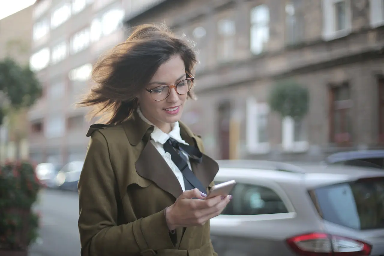 Person smiling looking at their phone.