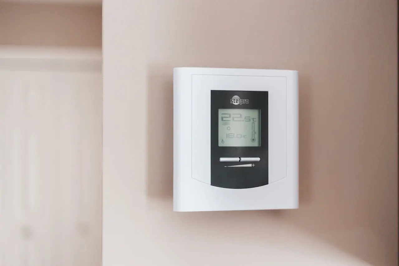 White smart thermostat on wall.