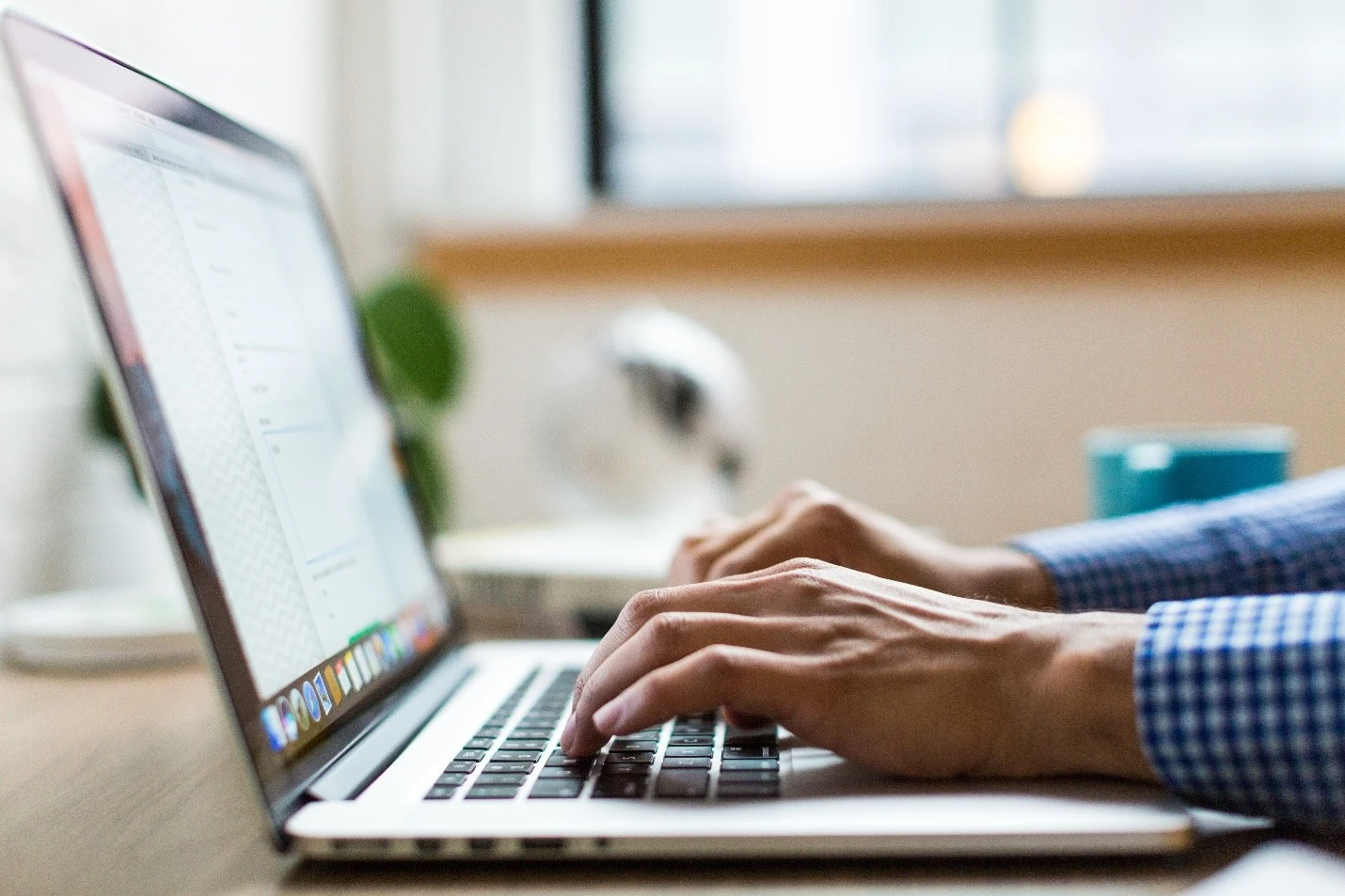 Person typing on laptop looking up how to pay off a loan.